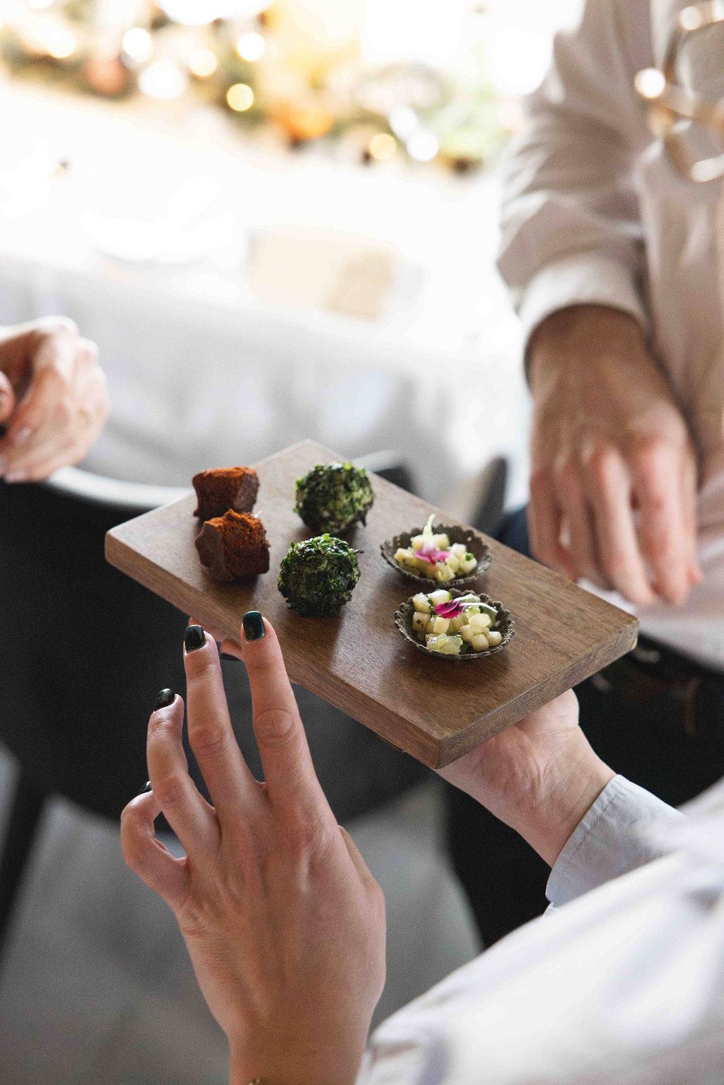 A board of canapés carried through the room