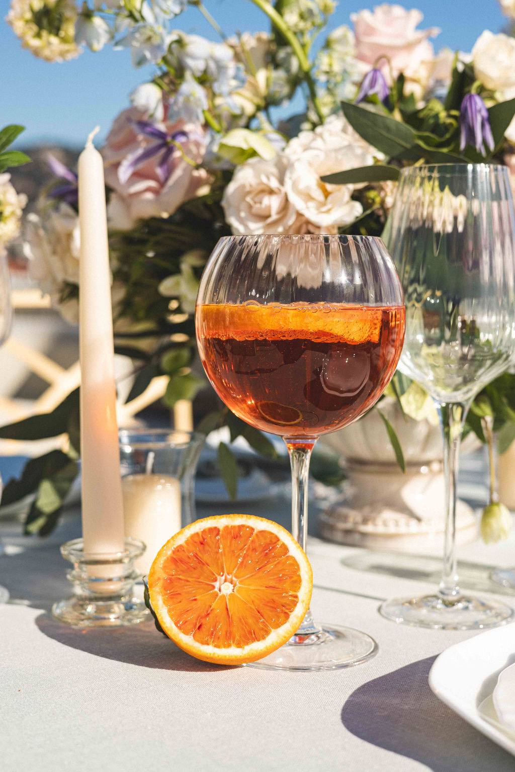 A spritz and half a blood orange on the table