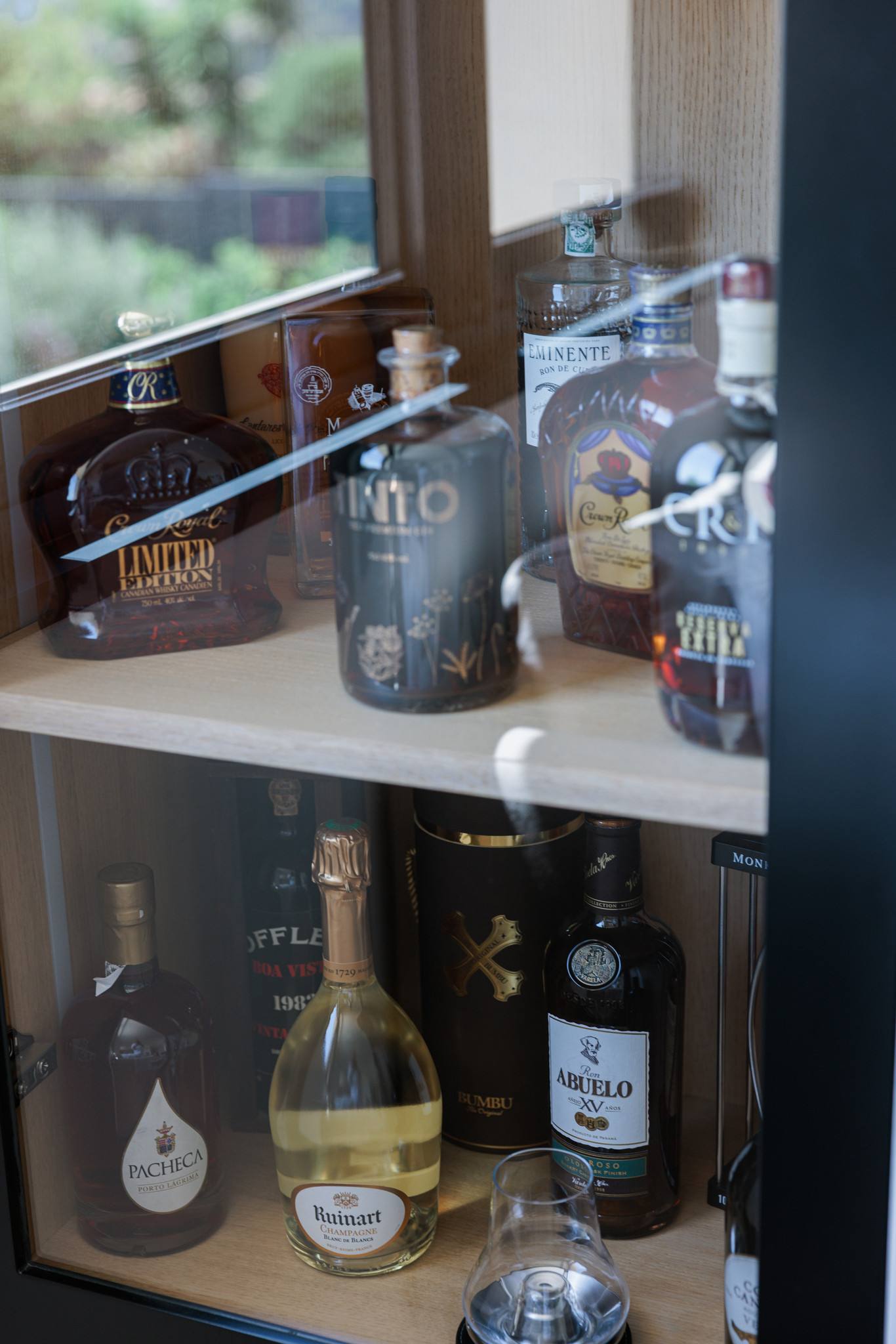 A cabinet of spirits and champagnes behind glass