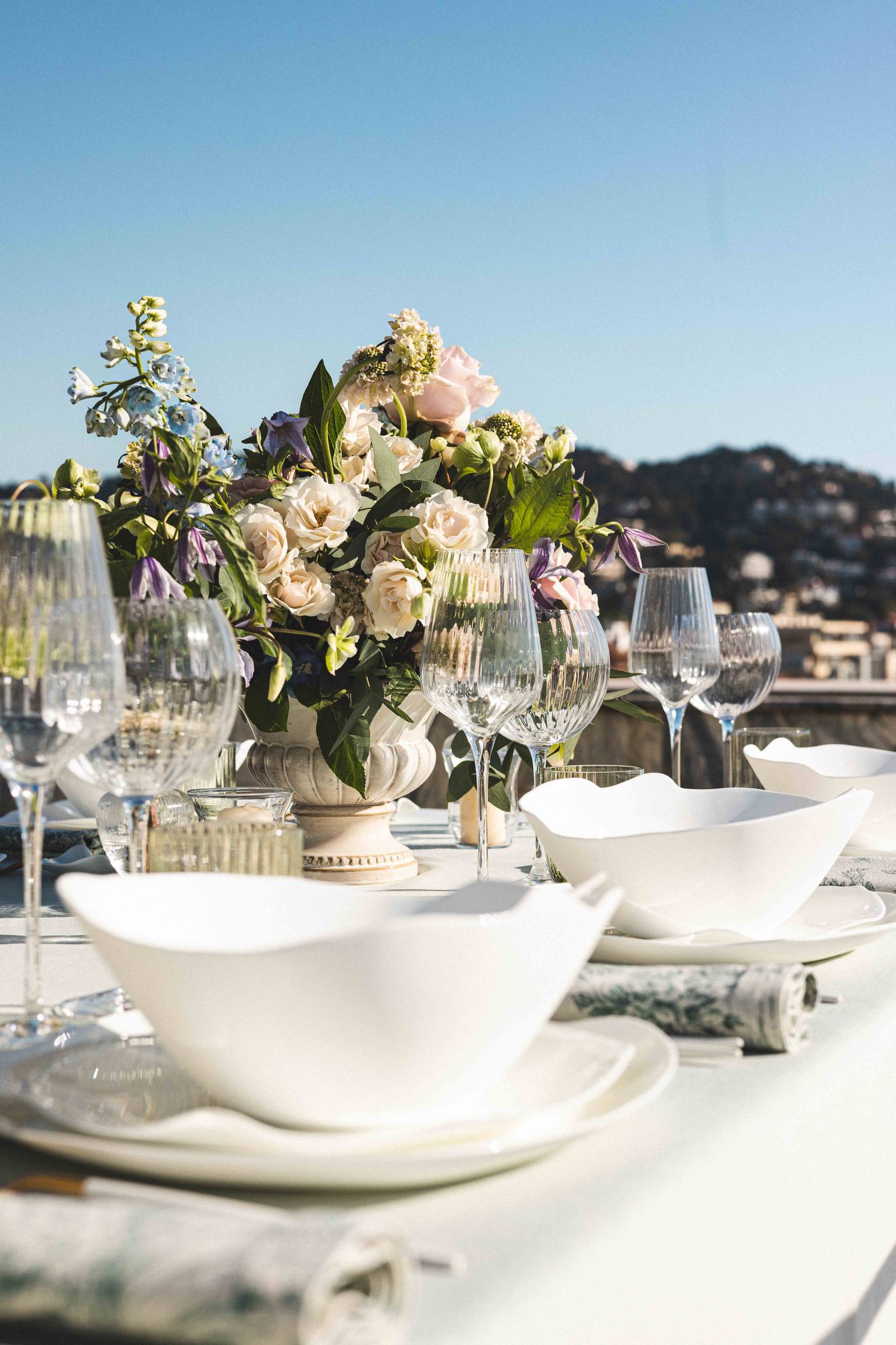 A floral centrepiece surrounded by fluted glassware