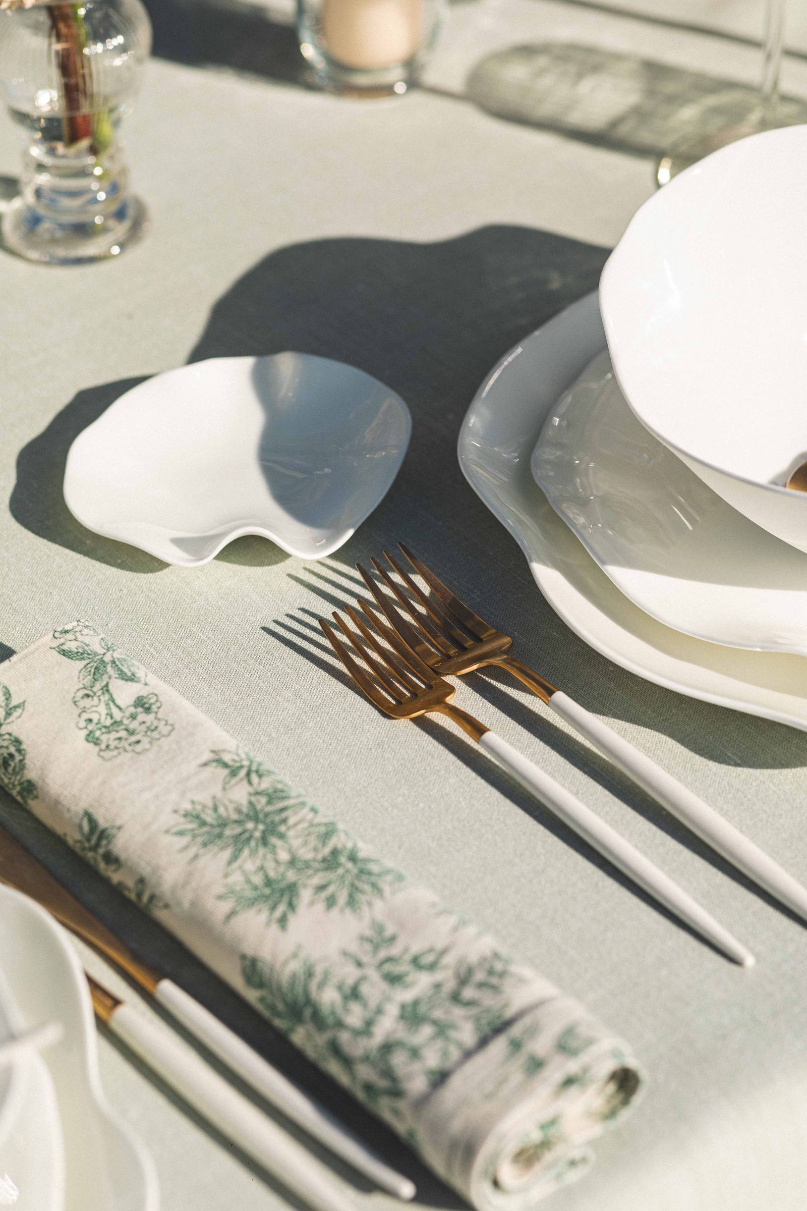 Gold cutlery beside a printed napkin