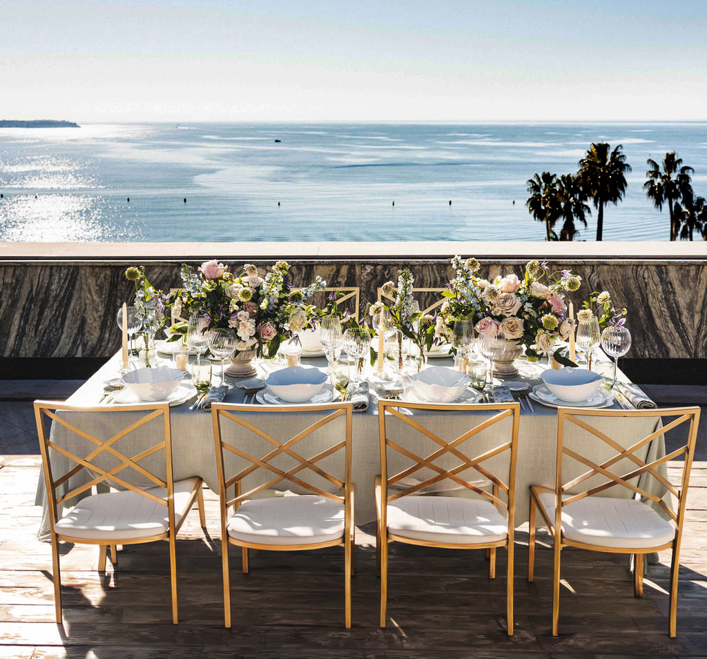 A table set on a terrace above the bay of Cannes