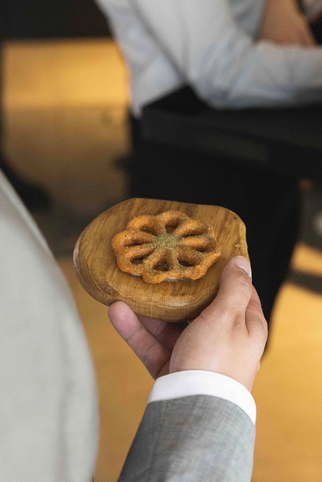 A golden socca presented on a wooden board