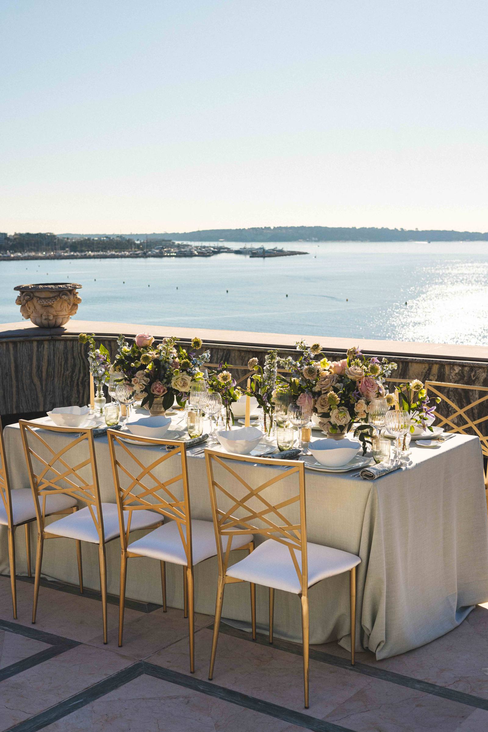 A table laid on the terrace, facing the bay
