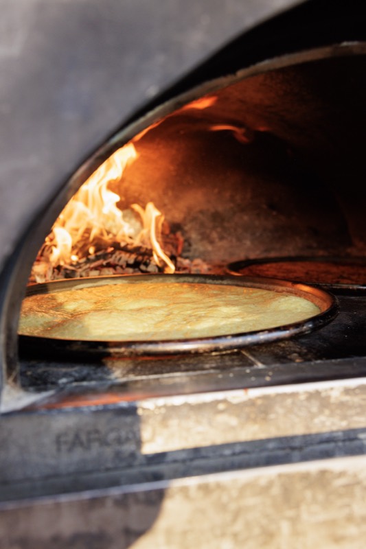 Wood-fired oven with a socca cooking